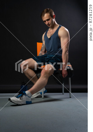 Man on black background keeps dumbbells pumped up in fitness active biceps body muscular fitness athletic heavy, male lifestyle. Lift human fit Man on black background keeps dumbbells pumped up in fitness active biceps body muscular fitness athletic heavy, male lifestyle. Lift human fit 87281259
