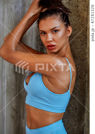 Fit, beautiful and sporty woman in blue sport underwear. Girl with a  perfect body posing in swimsuit Stock Photo by Gerain0812