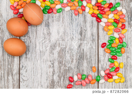 Easter background with eggs and colorful candies with space for text 87282066