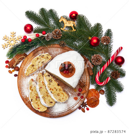 Sliced Traditional Christmas stollen cake with marzipan and dried fruit isolated on white background Sliced Traditional Christmas stollen cake with marzipan and dried fruit isolated on white background 87283574