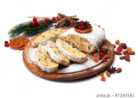Sliced Traditional Christmas stollen cake with marzipan and dried fruit isolated on white background Sliced Traditional Christmas stollen cake with marzipan and dried fruit isolated on white background 87283582