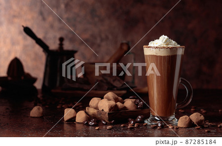 Truffles and glass of hot chocolate with whipped cream. 87285184