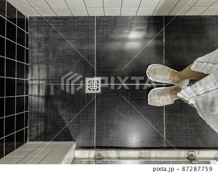 Floor drain, running water in shower, White and black tiles 87287759