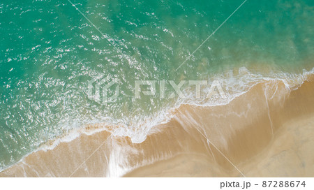 Aerial view sandy beach and crashing waves on sandy shore Beautiful tropical sea in the morning summer season image by Aerial view drone shot, high angle view Top down 87288674