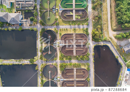 Aerial view High angle view Top down drone shot of the sewage treatment plant.The Solid contact clarifier tank type sludge recirculation in water treatment plant. Industrial wastewater treatment plant 87288684
