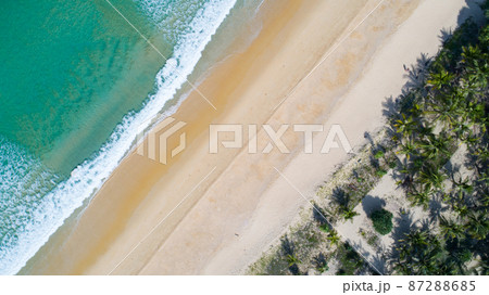 Aerial view sandy beach and crashing waves on sandy shore Beautiful tropical sea in the morning summer season image by Aerial view drone shot, high angle view Top down 87288685