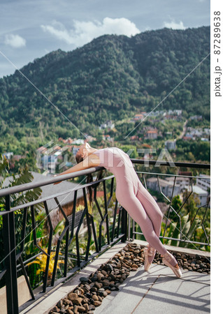 Young fit ballerina in pointes against mountainous landscape Ballerina dancing Young fit ballerina in pointes against mountainous landscape Ballerina dancing 87289638