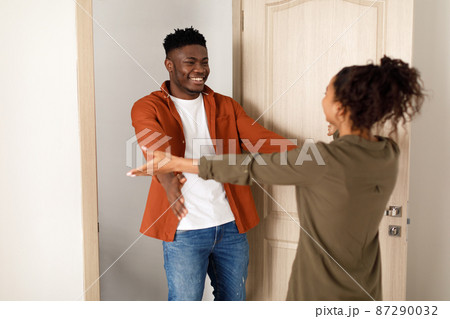 Cheerful Black Couple Stretching Hands For An Embrace At Home Cheerful Black Couple Stretching Hands For An Embrace At Home 87290032