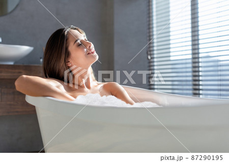 Closeup Shot Of Beautiful Lady Relaxing In Bathtub Filled With Foam Closeup Shot Of Beautiful Lady Relaxing In Bathtub Filled With Foam 87290195