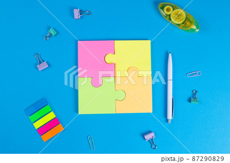 Blank sticky notes in the form of a puzzle on a blue background, space for text 87290829