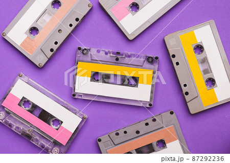 Collection of cassette tapes on purple background. 87292236