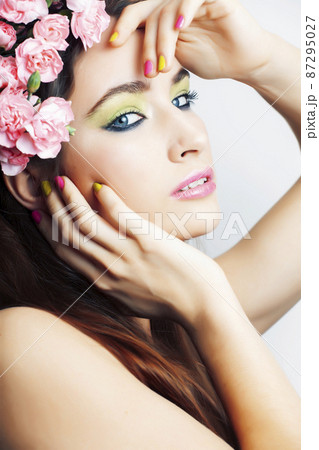 Beauty young real woman with pink flowers and make up closeup, spa salon, womans day concept Beauty young real woman with pink flowers and make up closeup, spa salon, womans day concept 87295027