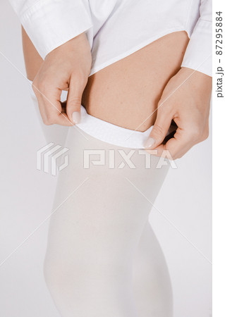 Anti-embolic Compression Hosiery for surgery isolated on white. Medical white stockings, tights for varicose veins and venouse therapy. Thrombo embolic deterrent hose or anti-embolism stockings. Anti-embolic Compression Hosiery for surgery isolated on white. Medical white stockings, tights for varicose veins and venouse therapy. Thrombo embolic deterrent hose or anti-embolism stockings. 87295884
