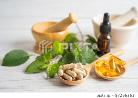 Alternative medicine herbal organic capsule drug with herbs leaf natural supplements for healthy good life. Alternative medicine herbal organic capsule drug with herbs leaf natural supplements for healthy good life. 87296363