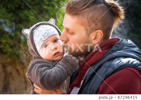 Young hipster father with his infant baby outdoor portrait Man is carrying her child and travel in nature 87296455