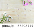 white and purple flowers on wooden background in aerial shot with copyspace 4 87298545
