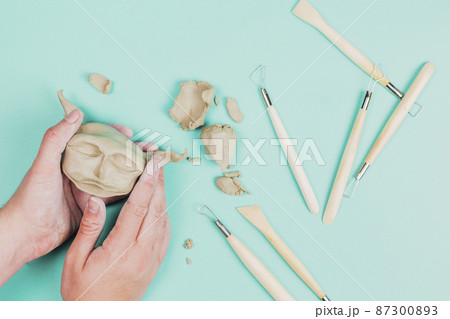 close up sculptor artist creating sculpture face with clay colored background close up sculptor artist creating sculpture face with clay colored background 87300893