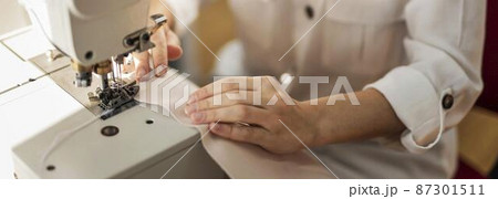 close up woman working with sewing machine close up woman working with sewing machine 87301511