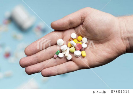 flat lay hand holding assortment pills flat lay hand holding assortment pills 87301512