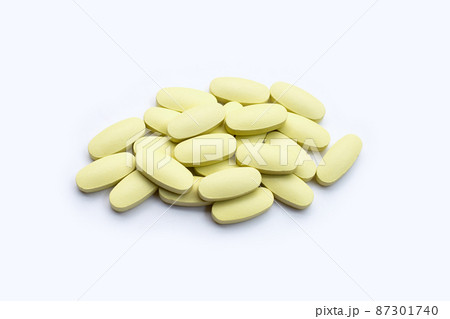 Vitamin c pills on white background. 87301740