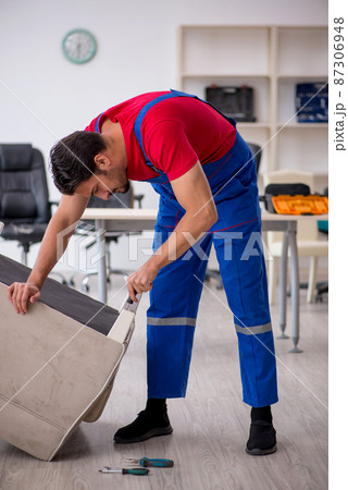 Young male carpenter working at workshop Young male carpenter working at workshop 87306948