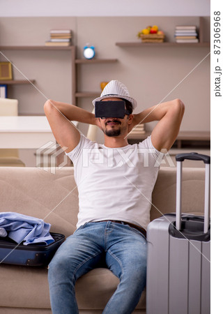 Young man preparing for trip at home Young man preparing for trip at home 87306968