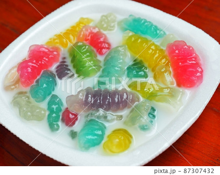 Caramelized crisps in coconut sauce.Thai dessert multi colored and sweet jelly in coconut milk. 87307432