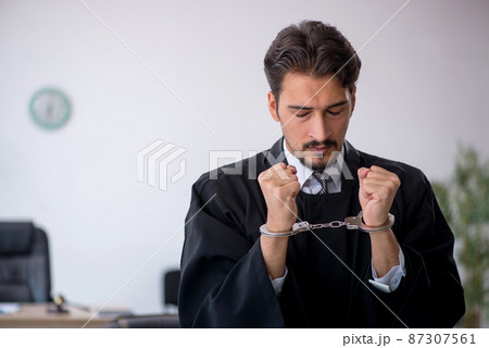 Young male judge in corruption concept 87307561