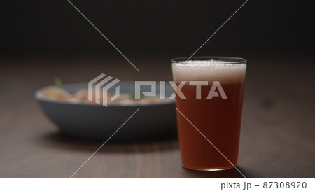 grapefruit drink in tumbler glass with blue bowl on background grapefruit drink in tumbler glass with blue bowl on background 87308920