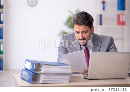 Young male employee working in the office Young male employee working in the office 87311138