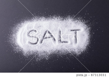 Overhead view of text carved over salt on black background Overhead view of text carved over salt on black background 87313031