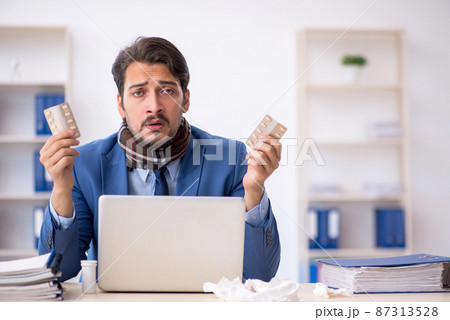 Young male employee suffering at workplace 87313528