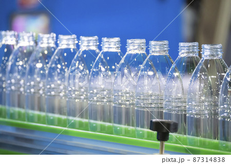 The empty PET bottles  on the conveyor belt for filling process in the drinking water factory. 87314838