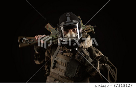 a man in a military uniform and a gas mask holds a weapon with an angry expression of emotion 87318127