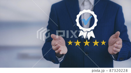 Quality assurance of business services and five star, Businessman hand shows the sign of the top service Quality assurance, Guarantee, Standards, ISO certification and standardization concept. 87320228