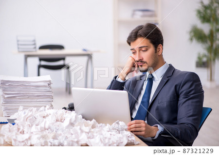 Young male employee in brainstorming concept Young male employee in brainstorming concept 87321229