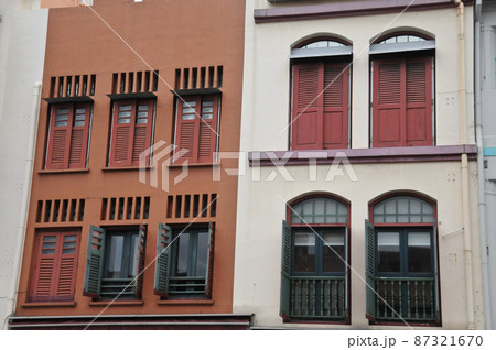 Classical dark orange and white grey front of town houses in Singapore in cloudy day 87321670