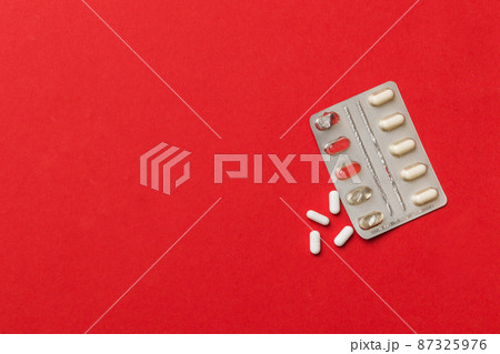 Protective face masks or surgical masks, medicine pills and thermometer on table background. Coronavirus disease. Corona virus concept. Space for text 87325976