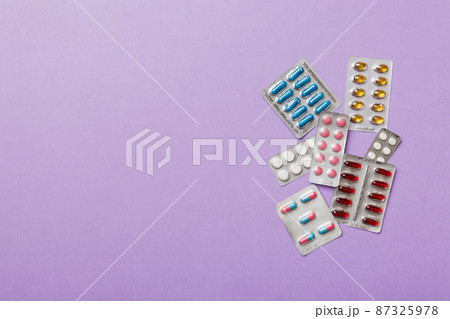 Protective face masks or surgical masks, medicine pills and thermometer on table background. Coronavirus disease. Corona virus concept. Space for text 87325978