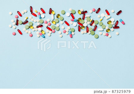 Protective face masks or surgical masks, medicine pills and thermometer on table background. Coronavirus disease. Corona virus concept. Space for text 87325979