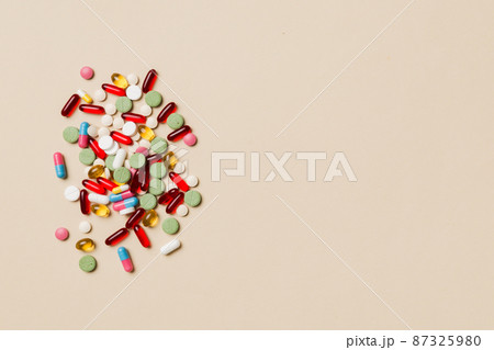 Protective face masks or surgical masks, medicine pills and thermometer on table background. Coronavirus disease. Corona virus concept. Space for text 87325980