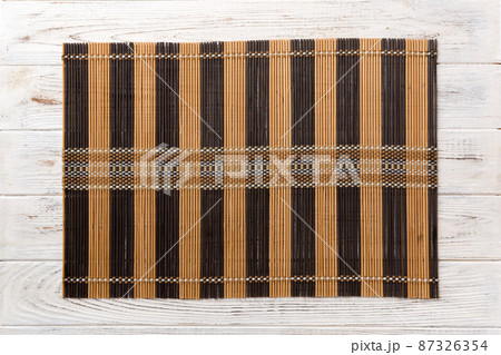 Top view of brown tablecloth for food on wooden background. Empty space for your design 87326354