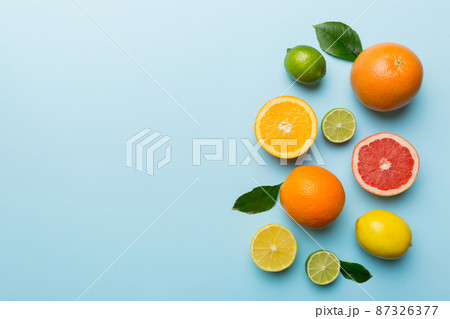 Fruit background. Colorful fresh fruits on colored table. Orange, lemon, grapefruit Space for text healthy concept. Flat lay, top view, copy space Fruit background. Colorful fresh fruits on colored table. Orange, lemon, grapefruit Space for text healthy concept. Flat lay, top view, copy space 87326377