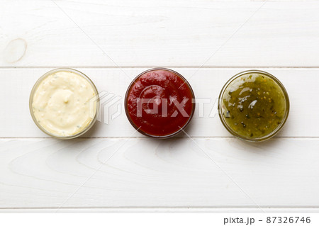 Different types of sauces in bowls on a colored Board . Top view. various sauces copy space 87326746