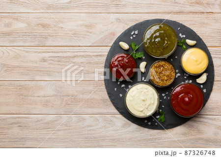 Many different sauces and herbs on table, flat lay top view. sauces on plate, healthy concept 87326748