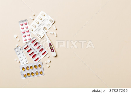 Protective face masks or surgical masks, medicine pills and thermometer on table background. Coronavirus disease. Corona virus concept. Space for text 87327296