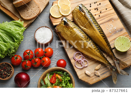 Flat lay composition with tasty smoked fish on wooden table Flat lay composition with tasty smoked fish on wooden table 87327661