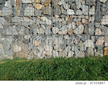 Gabion, a modular containment system made from wire mesh and filled with stones 87328867