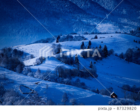 night is coming, old house covered with snow on the background of the forest night is coming, old house covered with snow on the background of the forest 87329820
