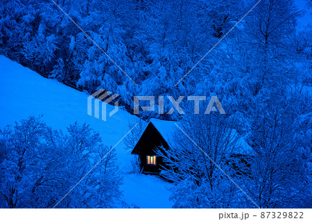 night is coming, old house covered with snow on the background of the forest night is coming, old house covered with snow on the background of the forest 87329822